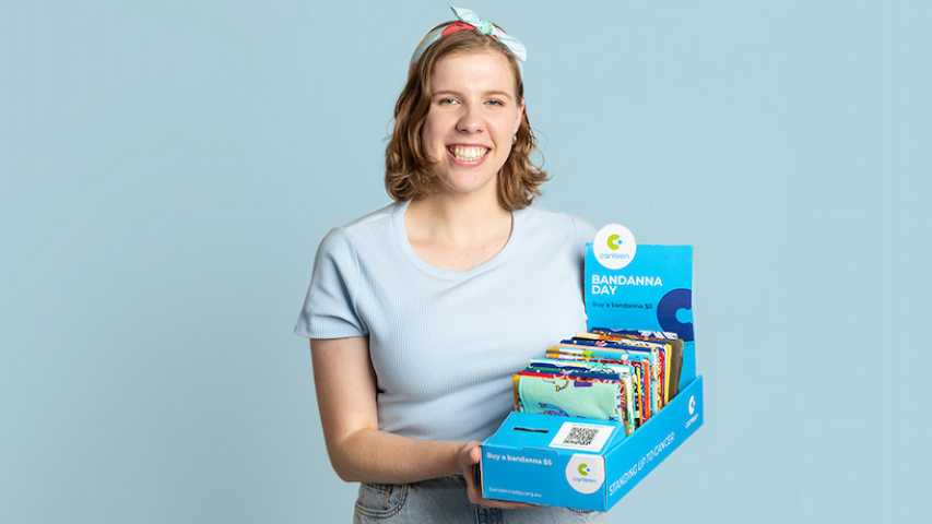 Young person holding a box of Canteen Bandannas