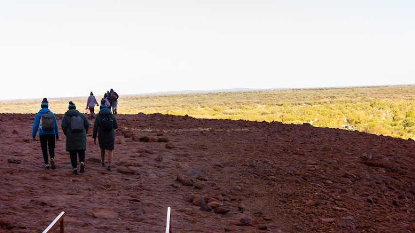 group of young people from canteen walking through Anangu Island