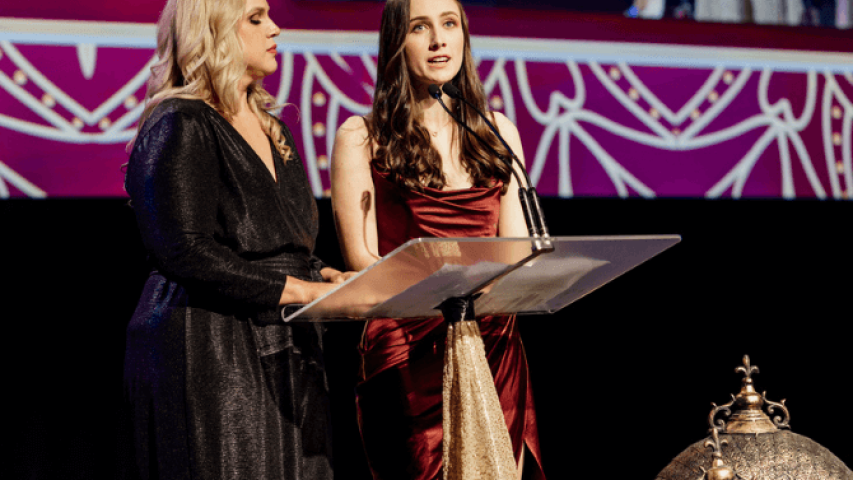 Sally and Alicia speaking on stage at the event