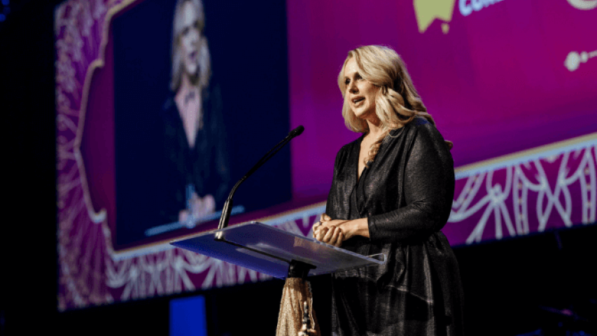 Sally speaking on stage at the event