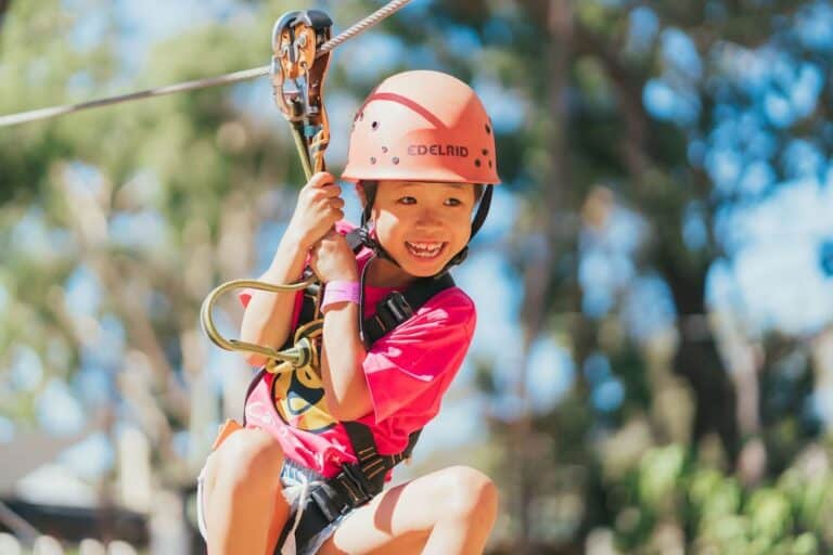 child on a zipline at a camp for cancer patients and families