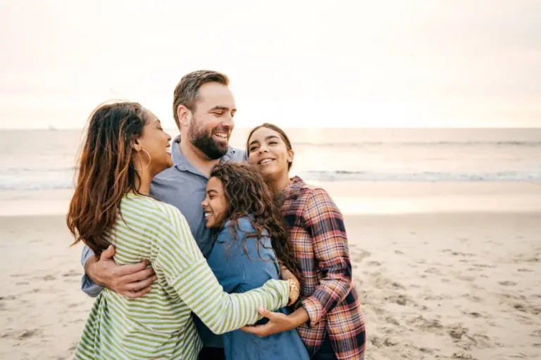A happy family gathering together on a beach